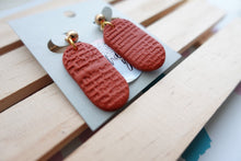 Load image into Gallery viewer, Small textured print | terracotta | pill shape | earrings | handmade
