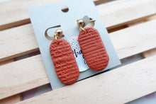 Load image into Gallery viewer, Small textured print | terracotta | pill shape | earrings | handmade
